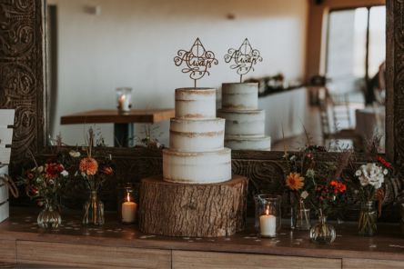Autumn British flowers bud vases semi naked cake on wedding table display with candles and book confetti Chalk Barn Dan Watkins My Flower Patch 